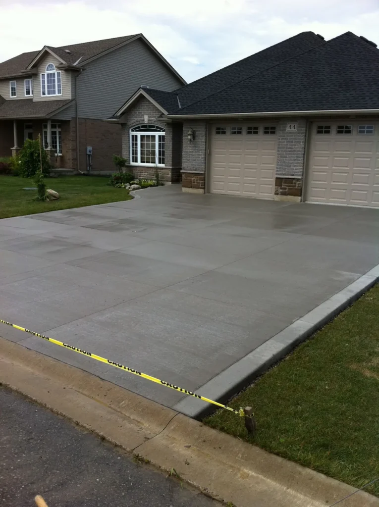 New broom-finished concrete driveway with control joints in Barrhaven, Ottawa
